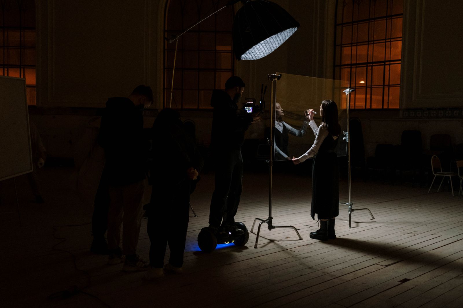 A crew lighting a themed set build inside the Backlot